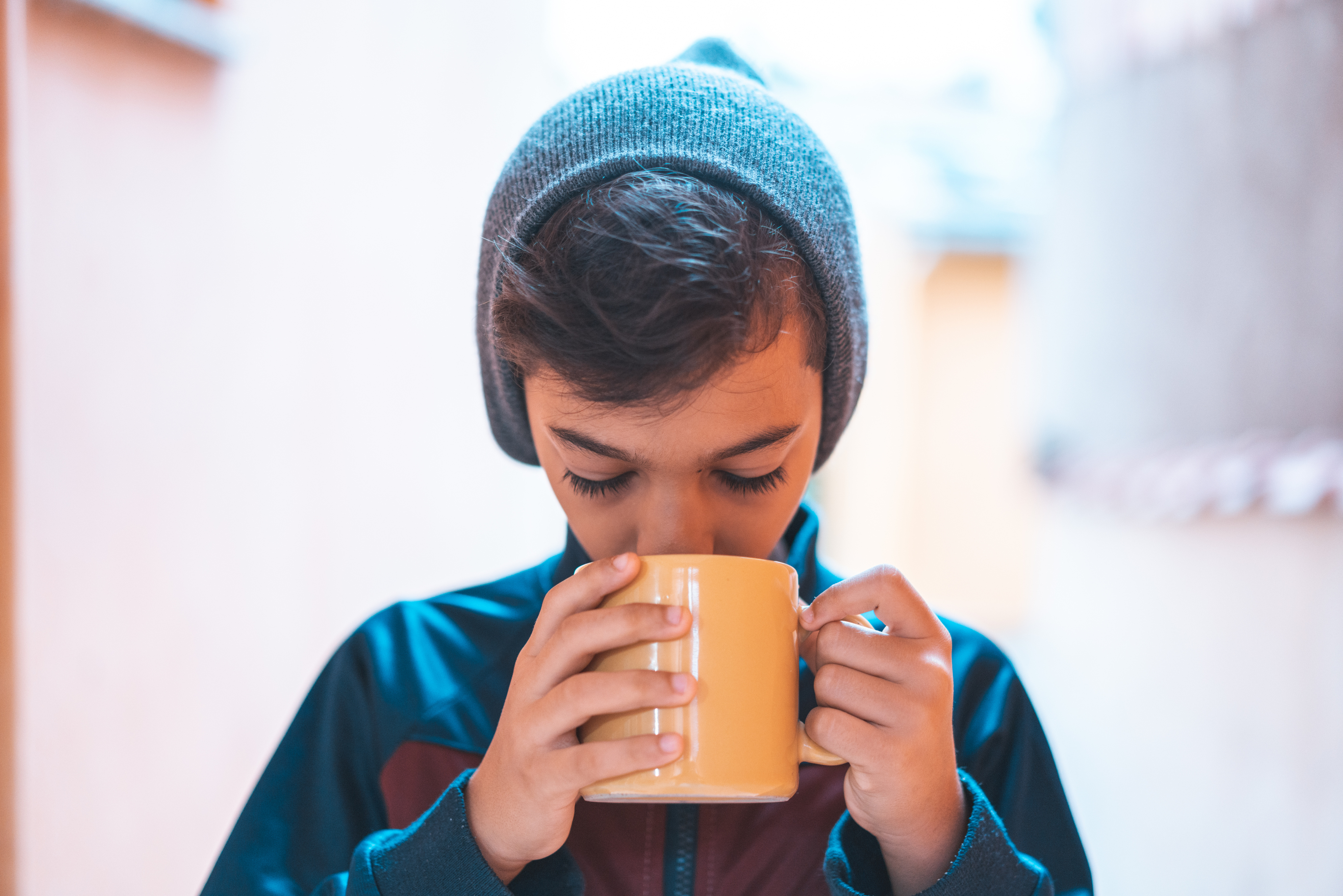 Boy drinking coffee on cold morning